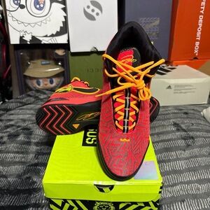 Red and Black Athletic Shoes with Orange Accents